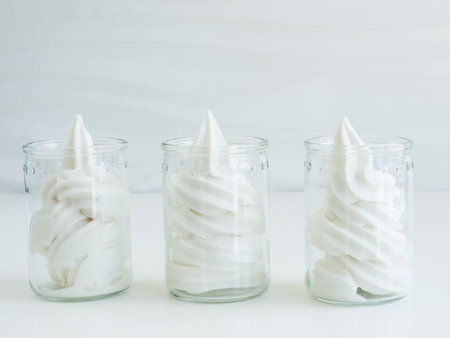 Frozen soft-serve yogurt in cup on white background.