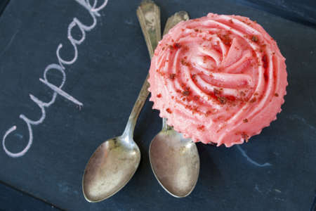 Gourmet red welveet cupcake on chalk board.の写真素材
