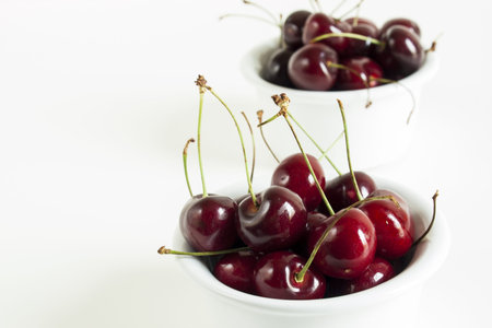 Freshly picked heap of cherries in bowl.