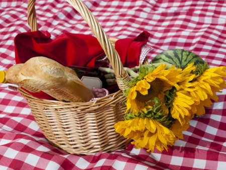 Picnic basket with fresh bread and wine.の写真素材