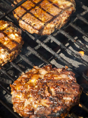 Gourmet hamburger parries on the grill.の写真素材