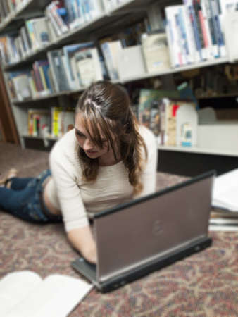 Teenage girl at the library.の写真素材