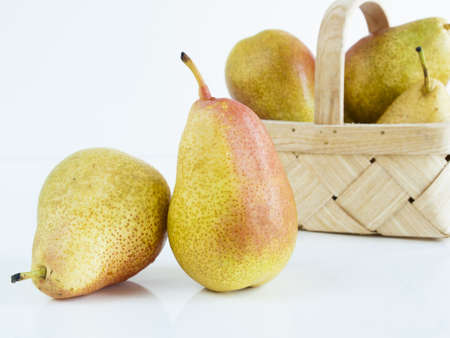 Ripe pear on white background. The cultivation of the pear in cool temperate climates extends to the remotest antiquity, and there is evidence of its use as a food since prehistoric times.の写真素材
