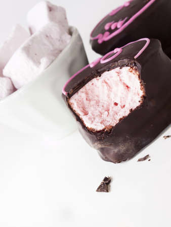 Gourmet chocolate covered strawberry marshmallows on white background.の写真素材