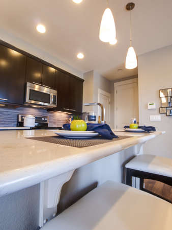 Modern kitchen with wood cabinets and stainless appliances.のeditorial素材