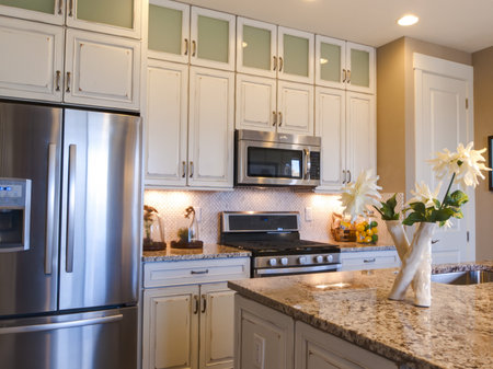 Modern kitchen with white cabinets and stainless appliances.のeditorial素材