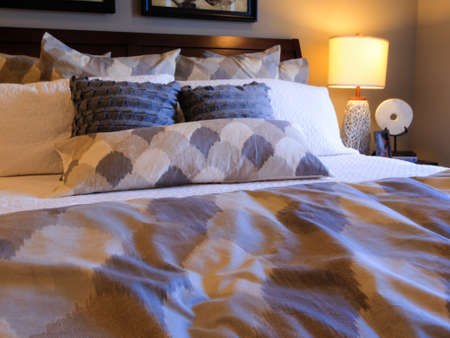 Modern master bedroom with large pictures and custom painted ceiling.のeditorial素材