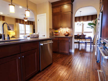 Modern kitchen with wood cabinets and stainless appliances.のeditorial素材