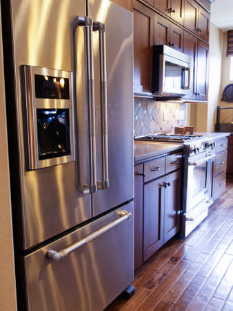 Modern kitchen with wood cabinets and stainless appliances.のeditorial素材