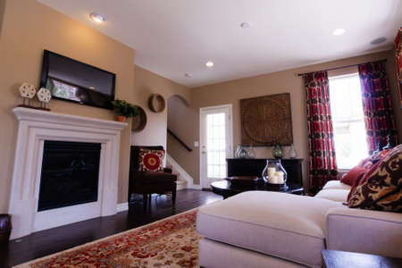 Modern living room with couch, coffee table, and fireplace.のeditorial素材