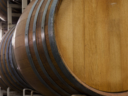 Wine barrels stacked in cellar area of vinery in Palosade, Colorado.