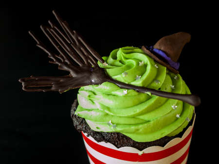 Halloween gourmet cupcakes with holiday decor black background.の写真素材