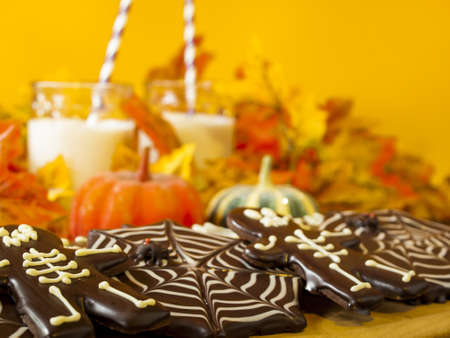 Halloween gourmet cookies with holiday decor orange background.の写真素材