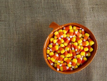 Traditional Halloween candies candy corn in orange bowl.の写真素材