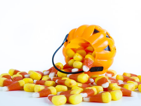 Candy corn candies falling out of Halloween treat bag.