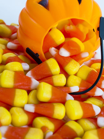 Candy corn candies falling out of Halloween treat bag.