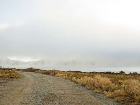 Early morning at the lake with fog in early Fall.の写真素材