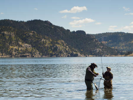 Father and son fishing together on early morning in late Fall.のeditorial素材