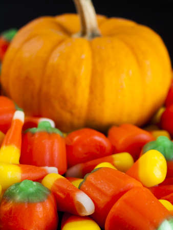Halloween candy corn and pumpkin candies on black background.の写真素材