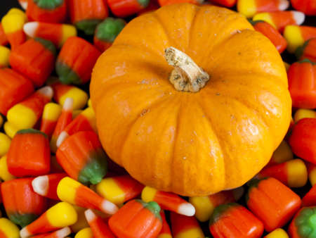Halloween candy corn and pumpkin candies on black background.の写真素材