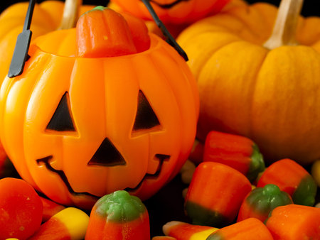 Halloween candies spilled on black background.の写真素材