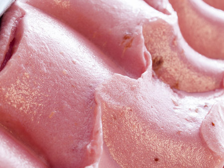 Gourmet sweet orange and cranberry gelato on white background.