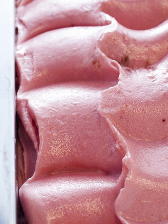 Gourmet sweet orange and cranberry gelato on white background.