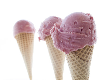 Gourmet sweet orange and cranberry gelato on white background.