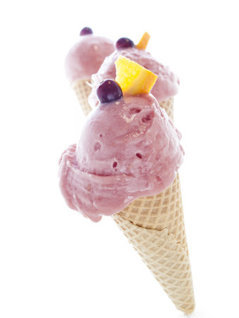 Gourmet sweet orange and cranberry gelato on white background.