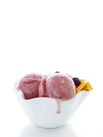 Gourmet sweet orange and cranberry gelato on white background.