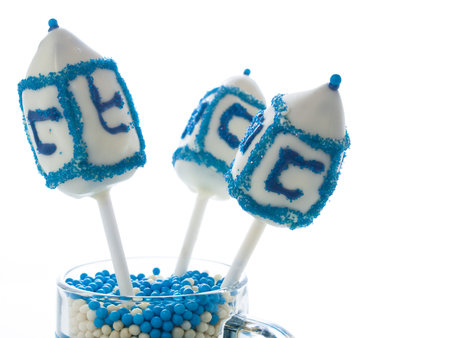 Gourmet dreidels decorated with white icing for Hanukkah.