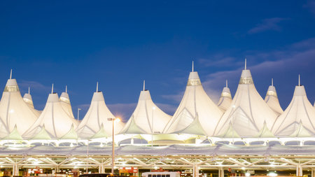 Denver International Airport at dusk with cloudy sky.のeditorial素材