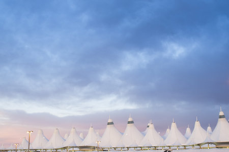 Denver International Airport at dusk with cloudy sky.のeditorial素材