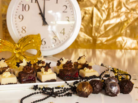Gourmet assorted petite party pastries decorated for New Year Eve celebration.の写真素材
