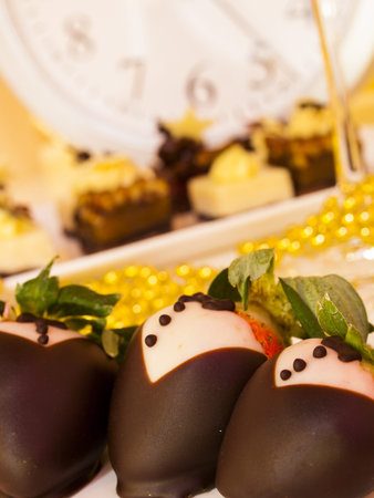 Gourmet assorted petite party pastries decorated for New Year Eve celebration.の写真素材