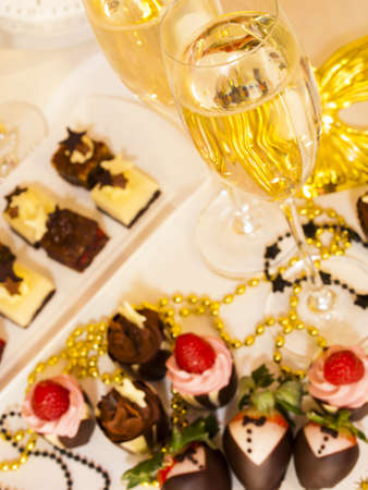 Gourmet assorted petite party pastries decorated for New Year Eve celebration.の写真素材