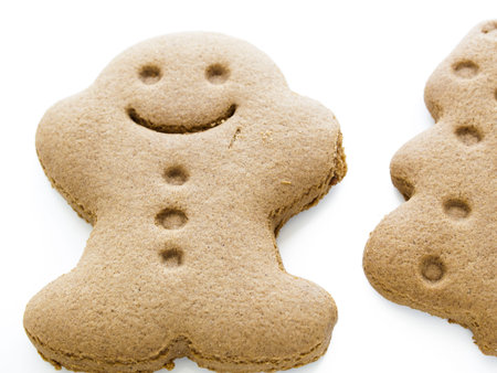 Gingerbread cookies ready to be decorated on white background.