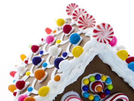 Decorated gingerbread house on white background.の写真素材