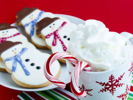 Hot chocolate with peppermint canes and snowman sugar cookies.の写真素材
