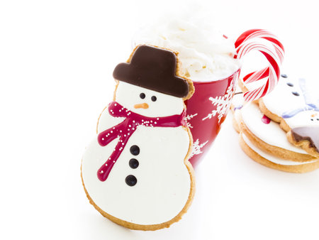 Gourmet snowman cookies with hot chocolate on white background.