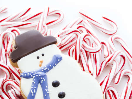 Gourmet snowman cookies with peppermint candy cane on white background.の写真素材