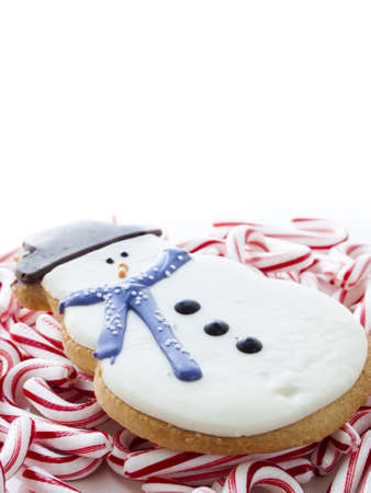Gourmet snowman cookies with peppermint candy cane on white background.の写真素材