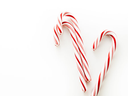 White and red peppermint candy cane on white background.の写真素材