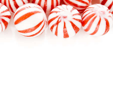 Gourmet white and red peppermint candies on white background.の写真素材