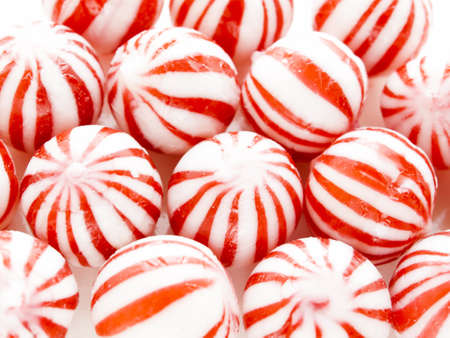 Gourmet white and red peppermint candies on white background.の写真素材