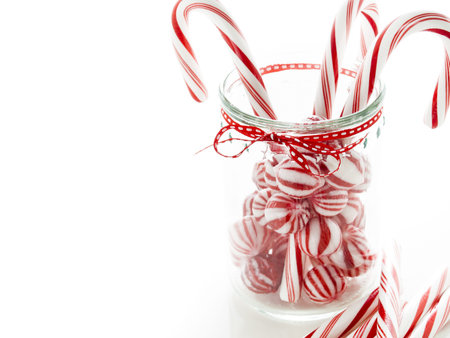 Gourmet white and red peppermint candies on white background.