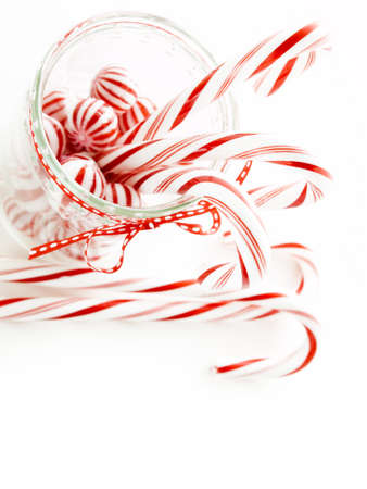 Gourmet white and red peppermint candies on white background.の写真素材