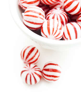 Gourmet white and red peppermint candies on white background.の写真素材