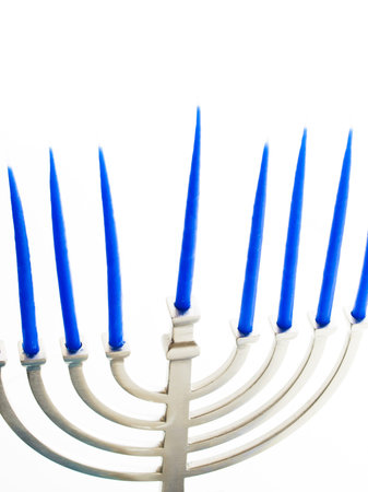 Contemporary menorah with blue candels on white background.の写真素材