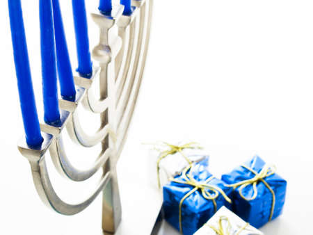 Contemporary menorah with blue candels on white background.の写真素材